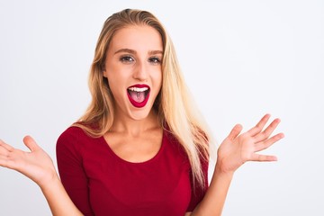 Young beautiful woman wearing red t-shirt standing over isolated white background very happy and excited, winner expression celebrating victory screaming with big smile and raised hands