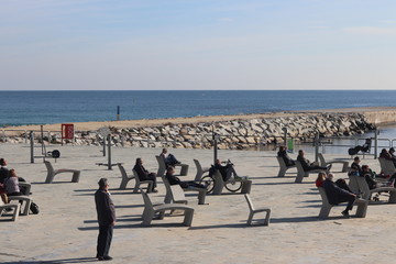 Gente anónima tomando tranquilamente el sol en un día de invierno