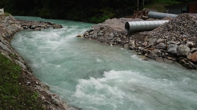 Water stream and construction pipes near Partnach Gorge.