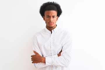 Young african american man wearing elegant shirt standing over isolated white background skeptic and nervous, disapproving expression on face with crossed arms. Negative person.