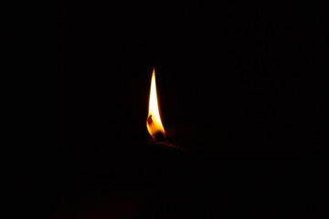 flame of diwali diya in the dark