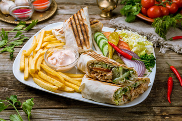 Shawarma on a plate on wooden table