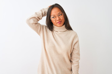 Young chinese woman wearing turtleneck sweater and glasses over isolated white background confuse...