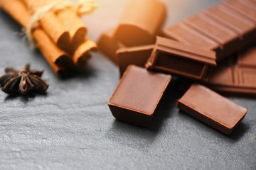 Chocolate bar and spice on dark background sweet dessert for snack