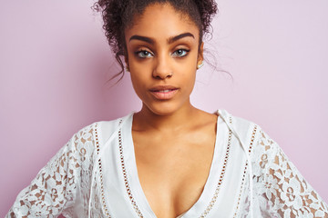 Young beautiful african american woman standing wearing elegant white dress