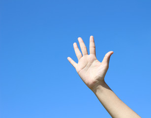 woman hand on blue sky background