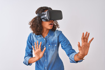 Young african american teenager girl playing virtual reality game using goggles