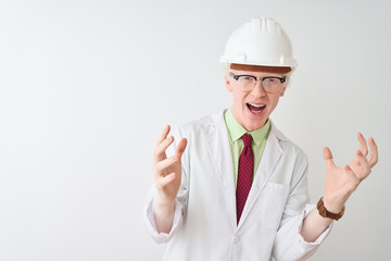 Albino scientist man wearing glasses and helmet standing over isolated white background celebrating crazy and amazed for success with arms raised and open eyes screaming excited. Winner concept