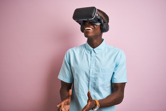 Young african american man playing virtual reality game using goggles