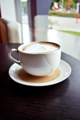 cup of coffee on wooden table