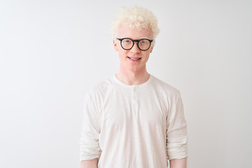 Young albino blond man wearing t-shirt and glasses standing over isolated white background with a...
