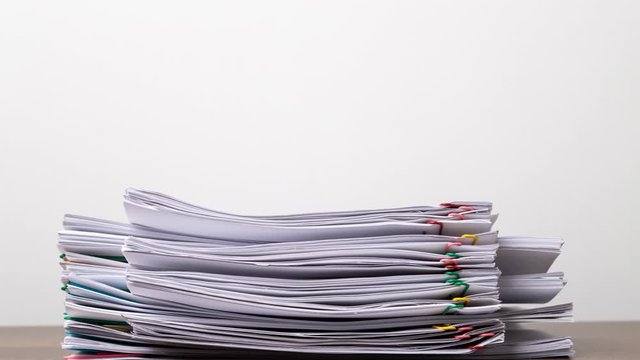 Stack overload document report paper with colorful paperclip place and copy space, business concept footage paperless used &ndash; 4K Stop motion.
