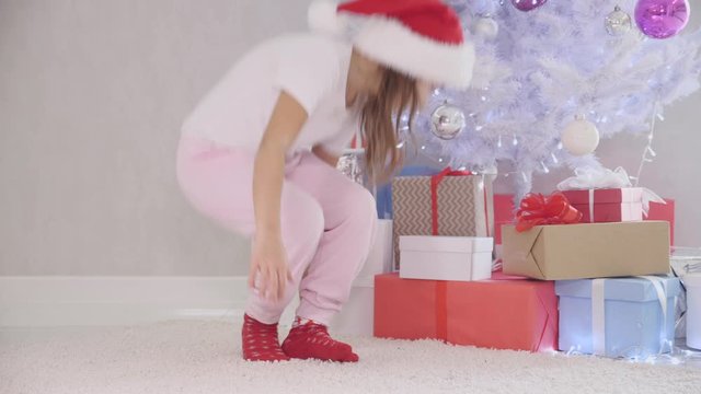 Interesting video of pretty kid slealing a gift box fom under the christmas tree at night.