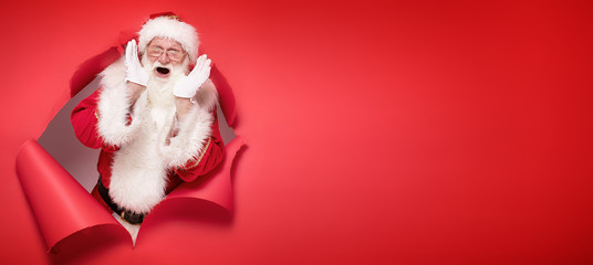 Emotional Santa Claus on the red background.