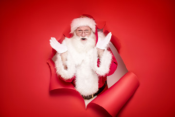 Emotional Santa Claus on the red background.