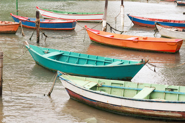 Fototapeta na wymiar Colorful wooden boats for fishing in the sea of Ribeiro beach in Vila Velha Espírito Santo Brazil