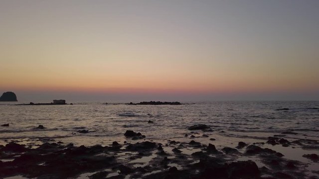 4K End of a sunset from a rocky beach of Pollonia, Milos, Greece.