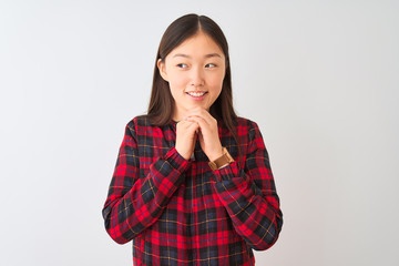 Young chinese woman wearing casual jacket standing over isolated white background laughing nervous and excited with hands on chin looking to the side