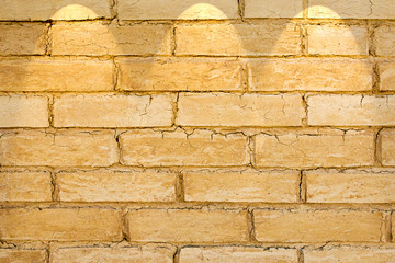 Adobe brick wall with spot lighting projection