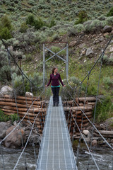 Woman Looks to Side While Standing on Bridge