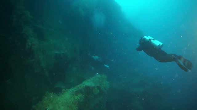 Shipwreck diving underwater in Truk Lagoon on Chuuk Islands. Wreck in historic place of terrible tragedy of WW II and diving among wreckage of ship.