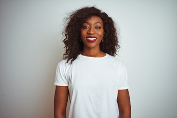 Young african american woman wearing t-shirt standing over isolated white background with a happy...