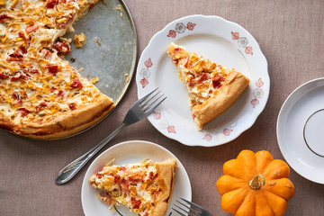 Piece of quiche with pumpkin and tomatoes