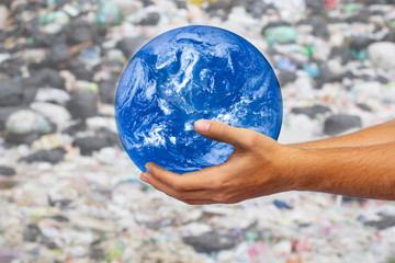 The hands of men holding the globle on garbage background . Ecology concept, earth day. Elements of this image furnished by NASA