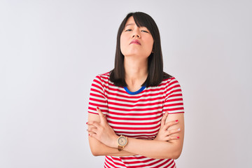 Fototapeta premium Young beautiful chinese woman wearing red striped t-shirt over isolated white background skeptic and nervous, disapproving expression on face with crossed arms. Negative person.