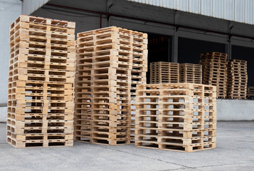 Stack of wooden pallets at storage warehouse. industrial logistics and cargo transport.