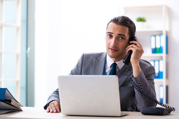 Young male accountant working in the office