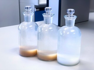BOD bottle for analysis Biochemical Oxygen Demand in waste water sample, precipitation with solvent in flask, can use as a science background. Selective focus, blur background blue laboratory.
