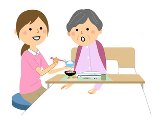 食事する高齢者　介護スタッフ 食事介助