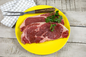 two raw steak in a plate