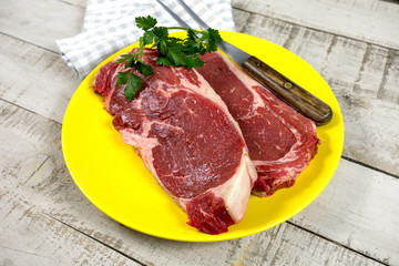 two raw steak in a plate