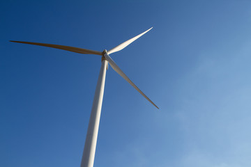 Power of wind turbine generating electricity clean energy on blue sky