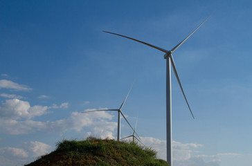 Power of wind turbine generating electricity clean energy on blue sky