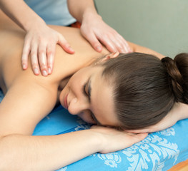 Obraz na płótnie Canvas Young girl lying on her stomach having massage