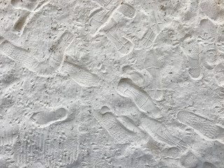 Footprints on white sand