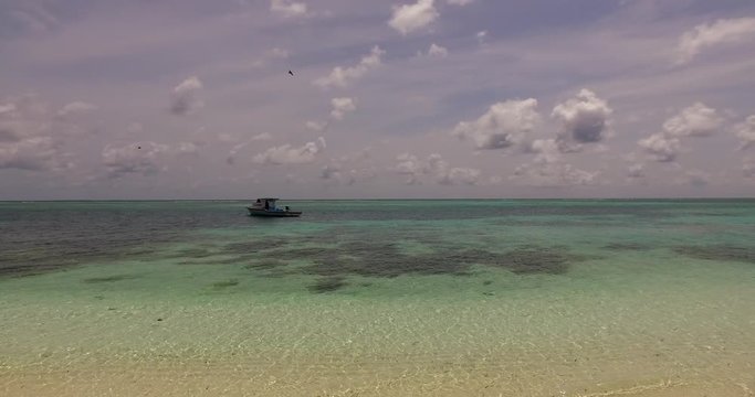 Beautiful tropical beach with fishing boat and turquoise water at Lombok Island, Indonesia.