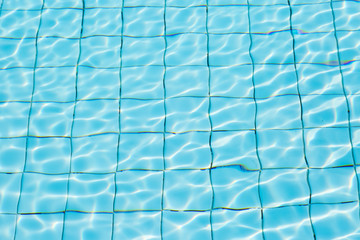 Water surface in blue swimming pool