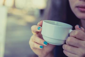 Woman drinking coffee in hand