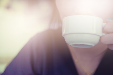 Fototapeta na wymiar Woman drinking coffee in hand