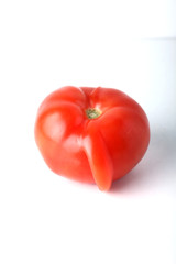 Concept of ugly food - ugly tomato on white background