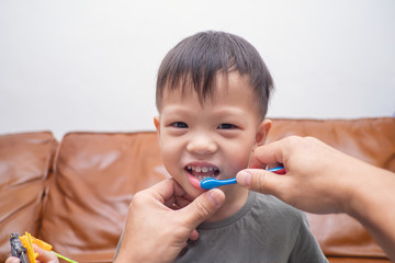 Asian father teaching kid teeth brushing, cute smiling little 3 - 4 years old toddler boy child brushing teeth in the morning at home, Tooth care for children, Child development concept