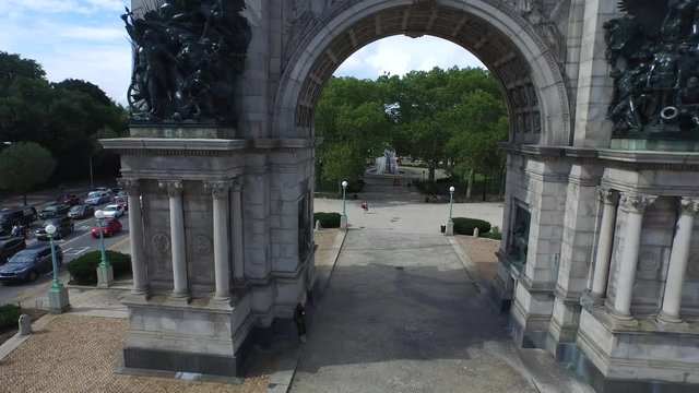 Cinematic arch fly through aerial of Grand Army Plaza revealing NYC skyline 4K.