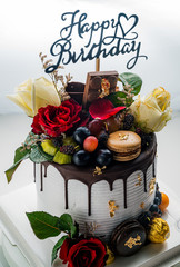 Happy birthday fresh fruit cake with Chocolate tag Homemade cake concept with strawberry kiwi fruit cake.