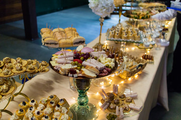 fancy elegant desert table with lot of sweets and candies.