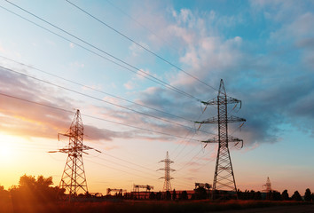 Fototapeta premium Electrical substation silhouette on the dramatic sunset background