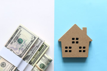 New home and Real estate concept, Model house with Orange ribbon and banknote on orange background, Finance and Banking